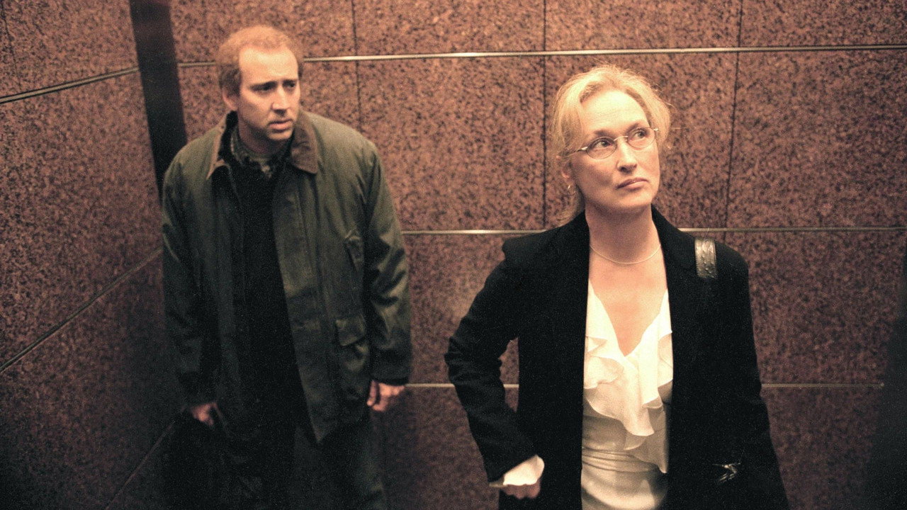 Charlie standing awkwardly beside Susan Orlean in an elevator
