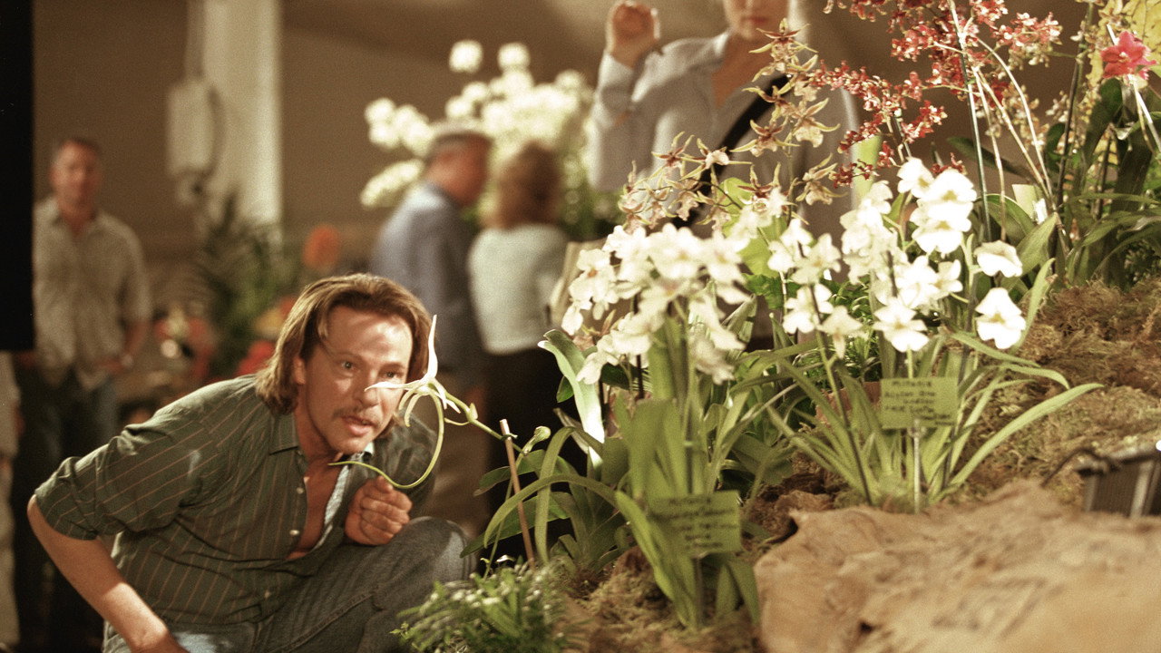 Laroche crouched at a crowded orchid show