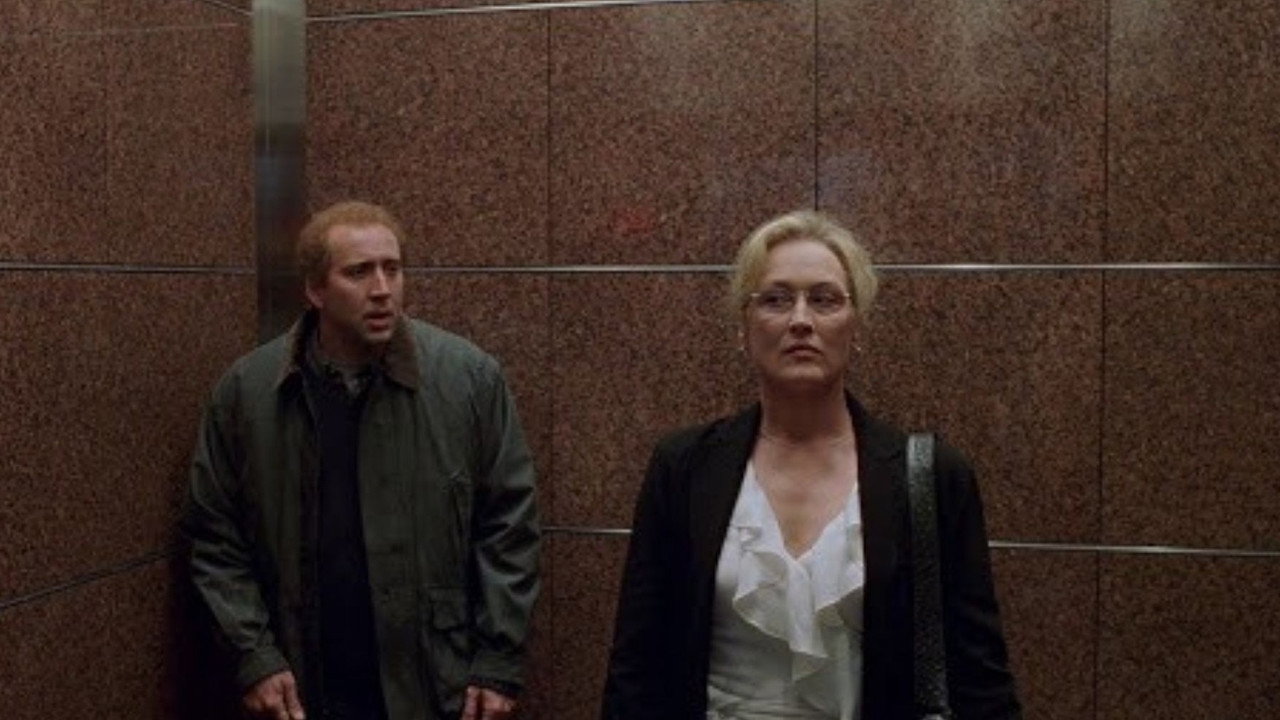 Charlie and Susan standing apart in an elevator