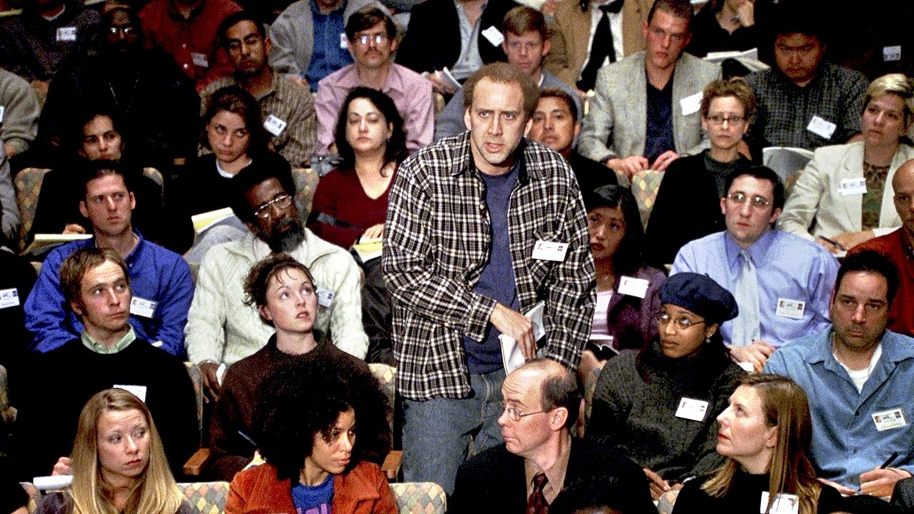 Charlie standing alone in a packed screenwriting seminar audience