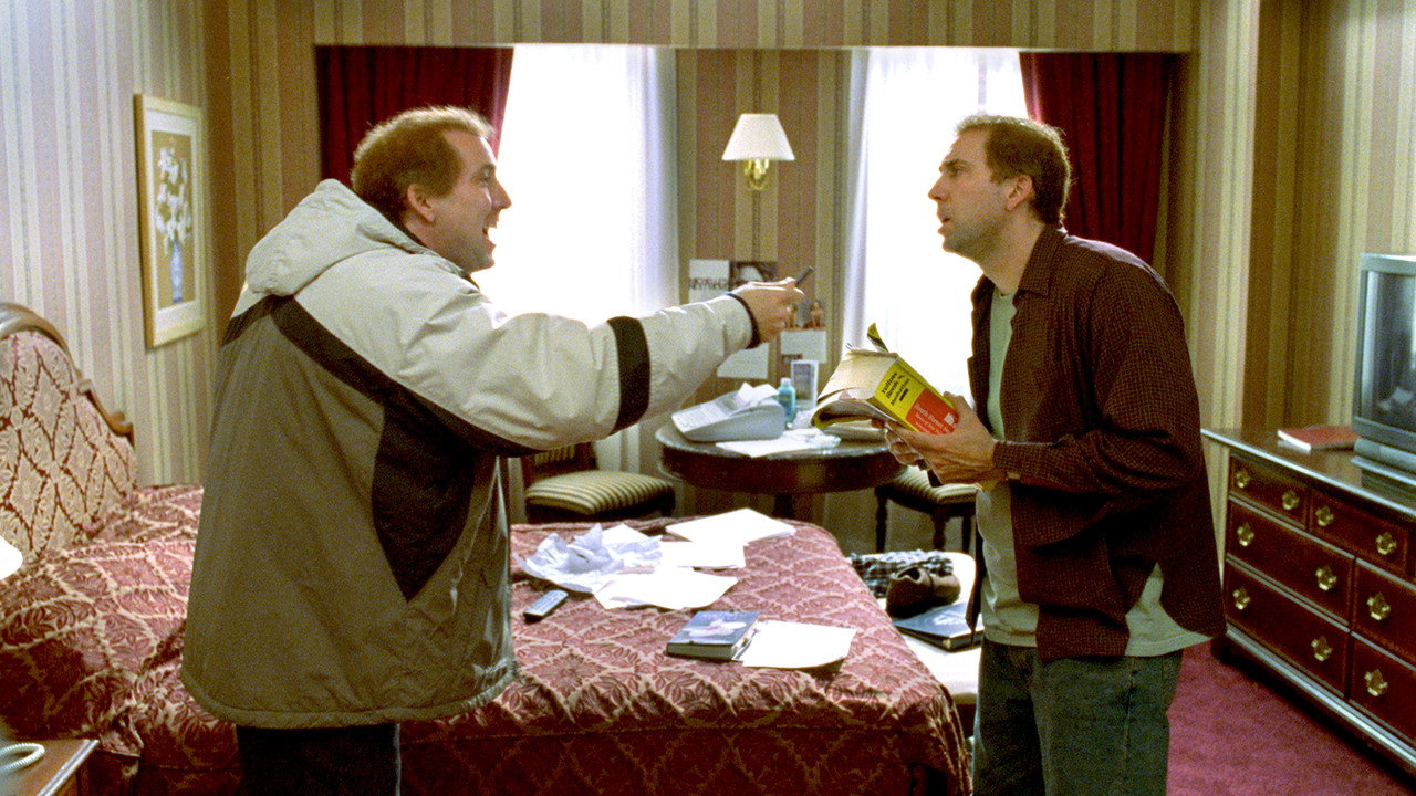 Nicolas Cage as both Charlie and Donald Kaufman facing each other in a hotel room