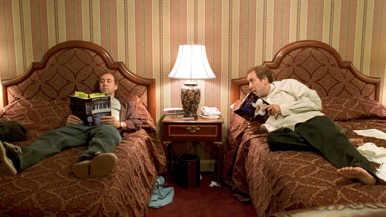 The two brothers on twin beds, one reading McKee's Story, the other reading The Orchid Thief