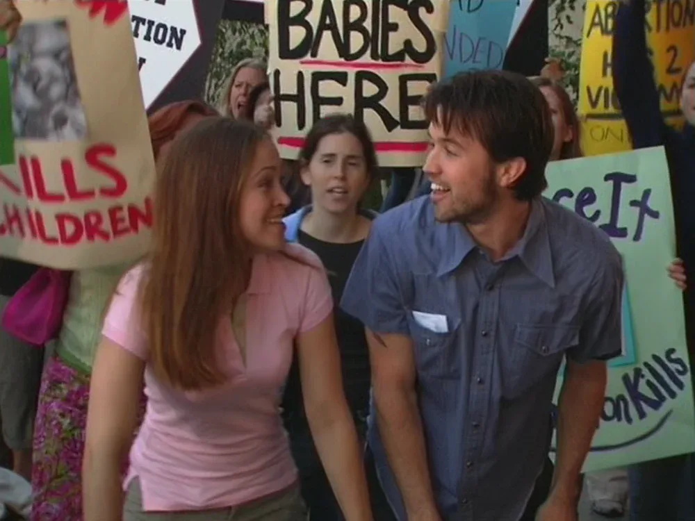 Still from It's Always Sunny S01E02: Mac and Megan at the rally