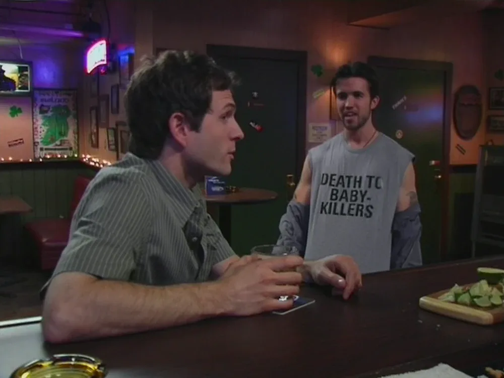 Still from It's Always Sunny S01E02: The rally's signage